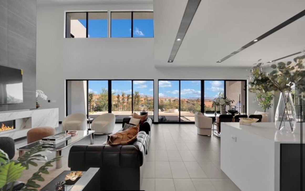 Modern great room with floor-to-ceiling windows and a linear fireplace